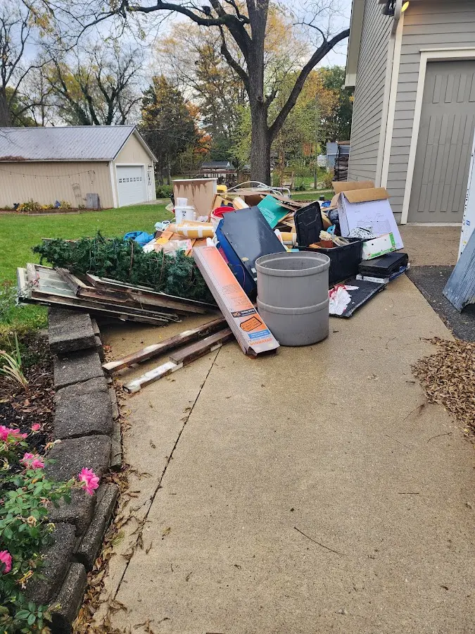 Dumpster being loaded with debris for Demolition Dumpster Rental in Independence